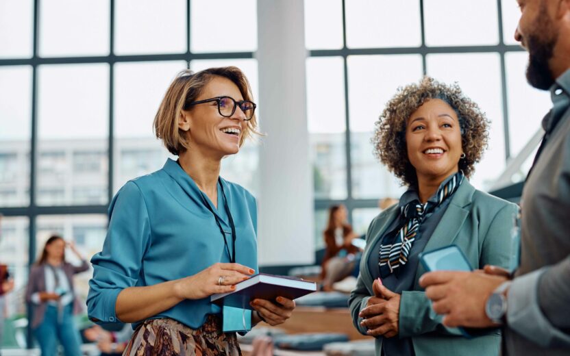 People smiling and talking at an event