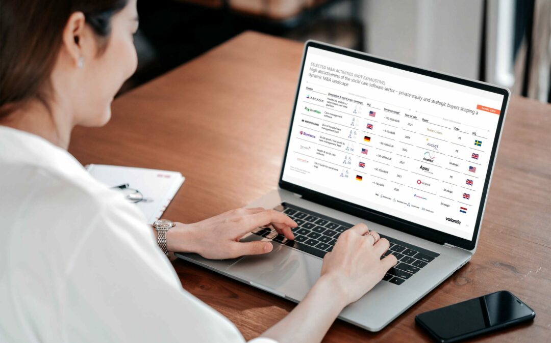 woman looking at slides on a laptop about m&a activities in the social care software market