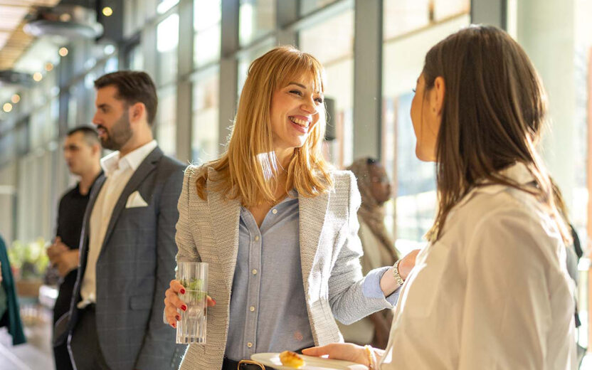 business people talking during break in event
