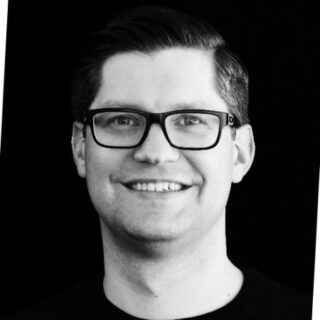 Christian Elsenhuber, Senior Manager DACH & CEE smiling in a black Shirt