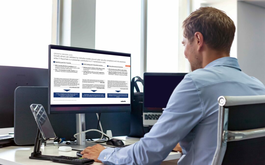 Man looking at a screen with slides on the Growth Drivers of the Healthcare IT Services Market