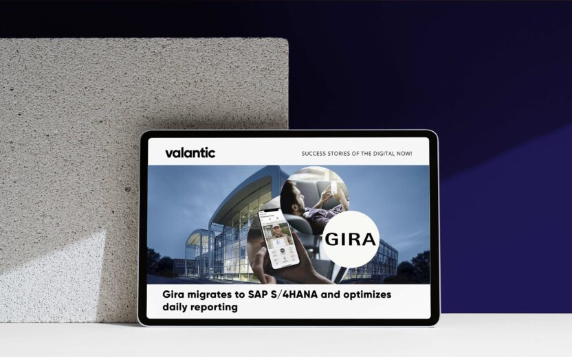 A tablet shows a business article about Gira's migration to SAP S/4HANA, accompanied by a large image of a building and a person using a phone. The piece highlights how SAP Analytics plays a crucial role in optimizing their transition.