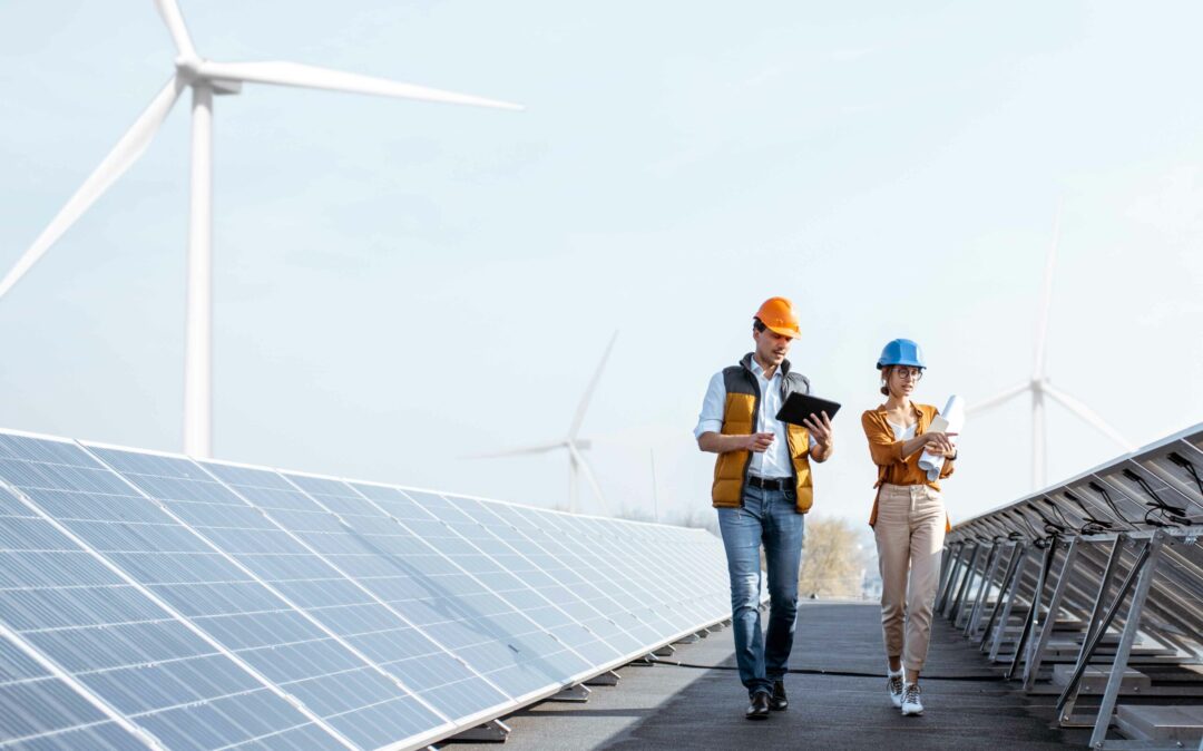 Two colleagues speak between energy plants and windmills for the EVU Process & IT Days 2026.