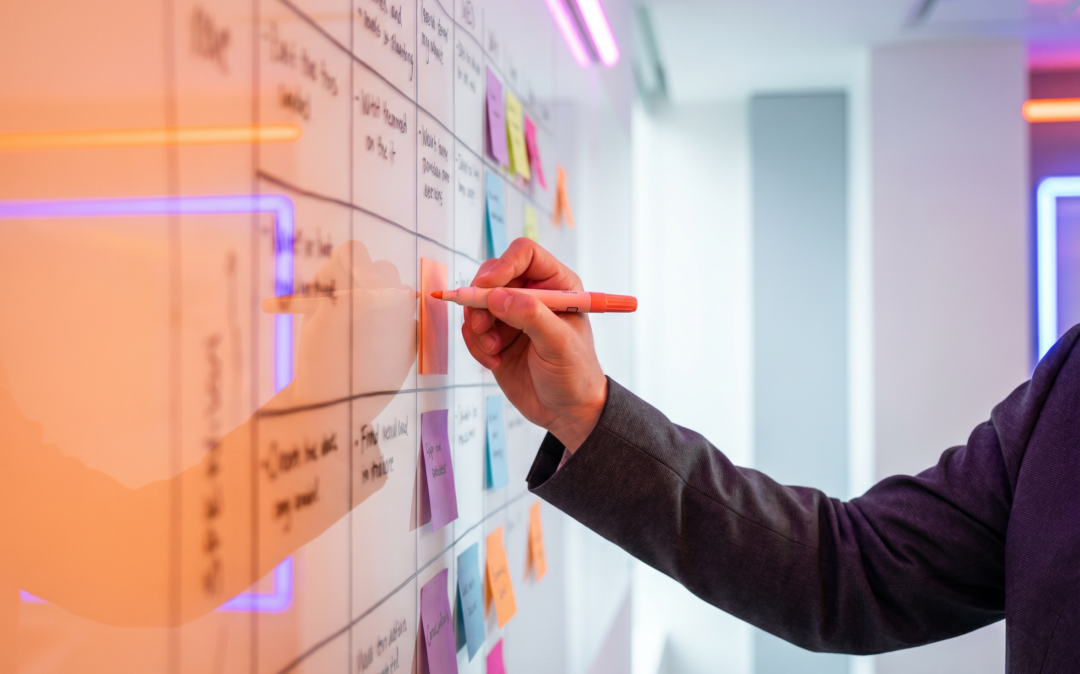 Hand marking tasks with a highlighter on a project planning board