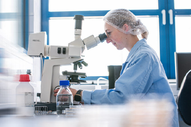 A Gerolsteiner employee working in quality control