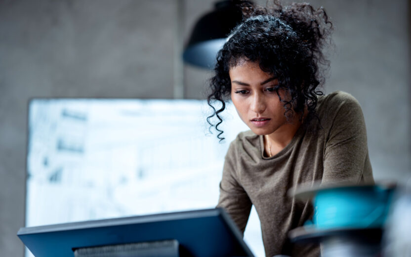 A woman working on a project in an office | valantic SAP Study 2026