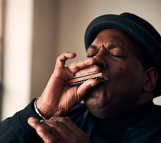 Image of musician and music producer keith dunn, playing on a HOHNER harmonica