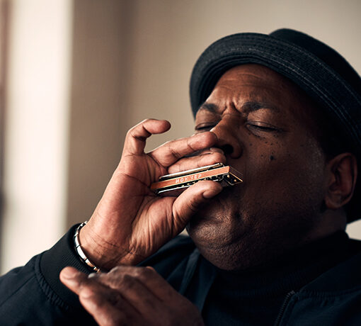Image of musician and music producer keith dunn, playing on a HOHNER harmonica