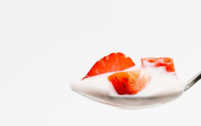 Picture of a spoon with yoghurt and strawberries valantic Case Study Müller