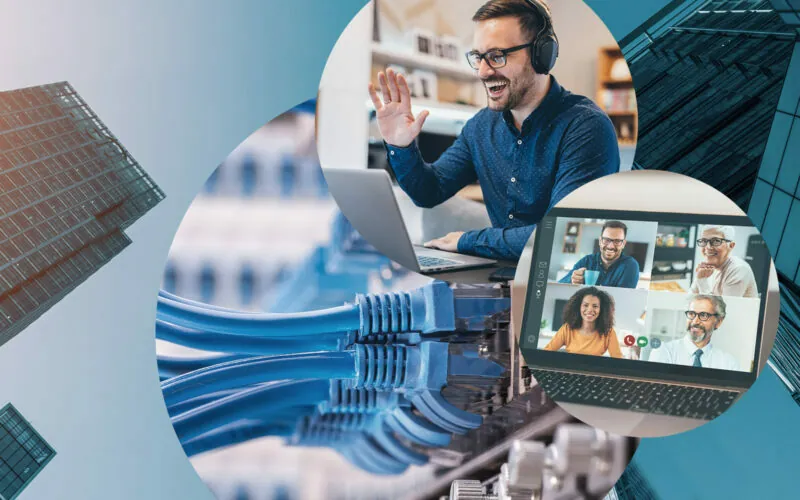 Bild eines Mannes, der in die Webcam seines Laptops winkt, darunter ist ein Bildschirm mit verschiedenen Teilnehmern eines Videocalls zu sehen, im Hintergrund Kabel sowie hohe Gebäude