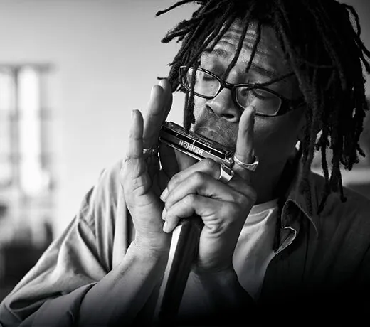 Foto eines Mannes der Mundharmonika spielt