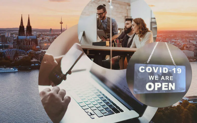 Image of three bubbles: In the first bubble there is a laptop and a mobile phone, next to it in the second bubble there is a sign saying "Covid 19 - We are open", in the tird bubble there are three people talking in front of a computer, in the background you see the skyline of Cologne