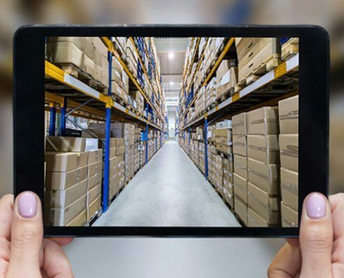 Picture of a tablet in a warehouse full of cartons, valantic warehouse commissioning