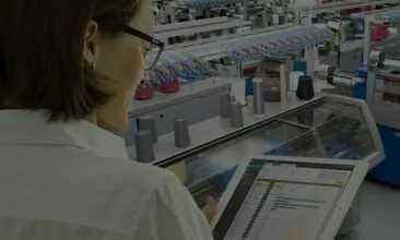 Picture of a woman with a tablet in a production plant, valantic Case Study Stoll