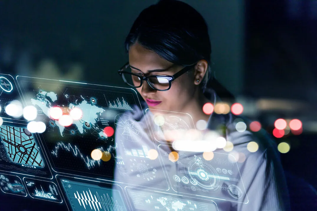 Image of a woman engineer looking at various information on screen with futuristic interface
