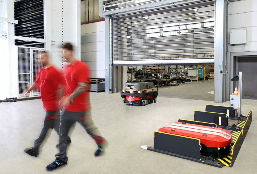 Image of two people and automated guided vehicles at Grenzebach