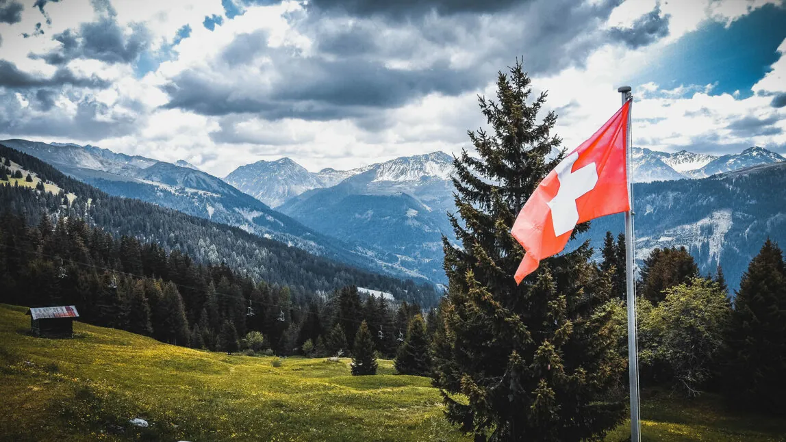Picture of the Swiss mountains with Swiss flag - Success Story Emmy - MicroStrategy