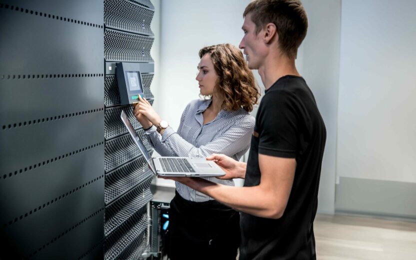 oung IT Engineers Working in Supercomputer Electricity Backup Room
