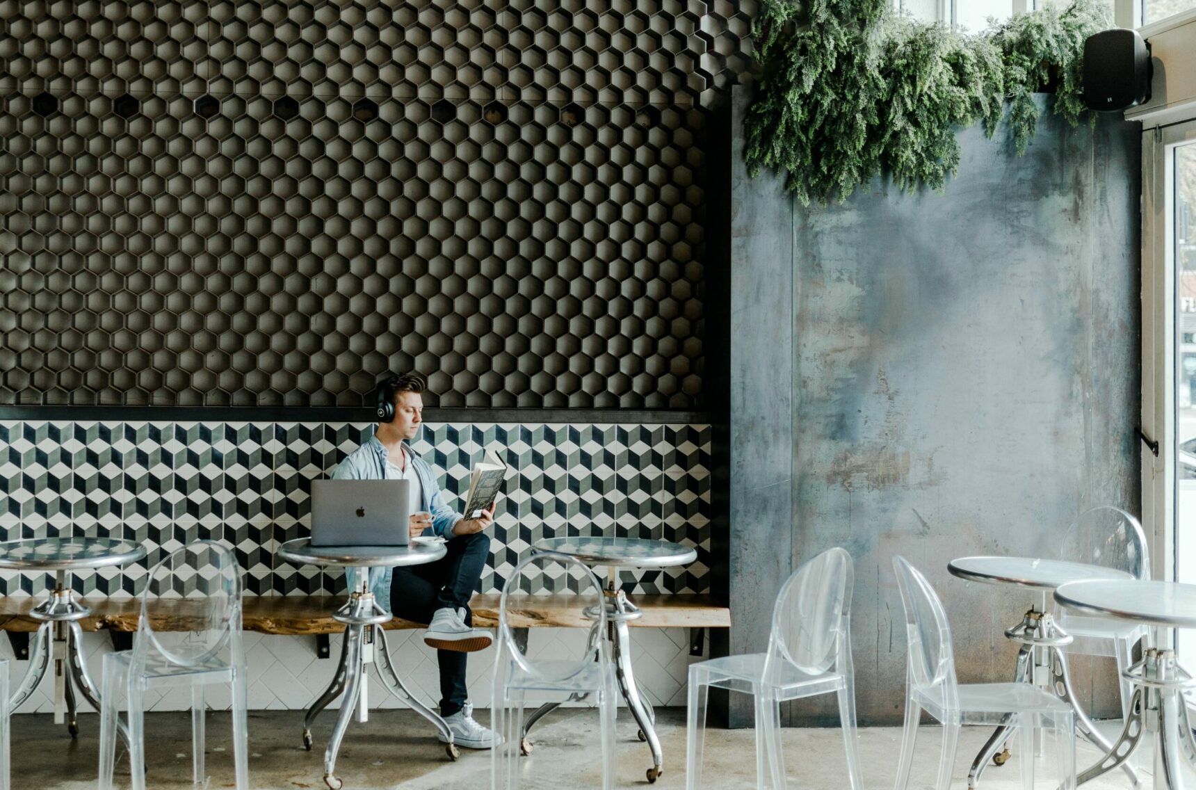 Bild von einem Mann im Café mit Laptop und Buch, Digital Now Magazin valantic New Work