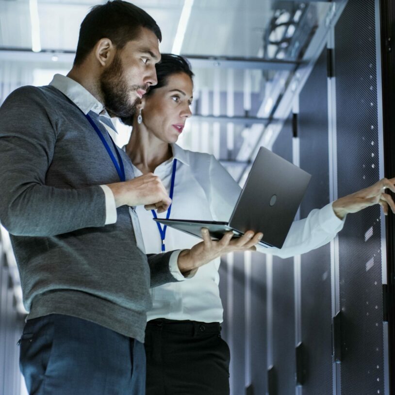 Image of two people in a server room, digital strategy & analytics range of services valantic
