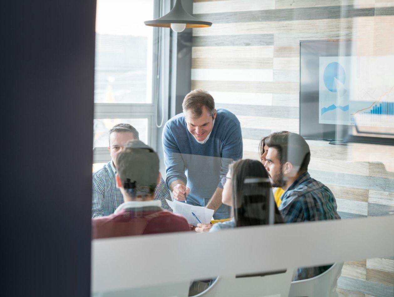 Image of a group of people sitting in a meeting room, SAP consolidation