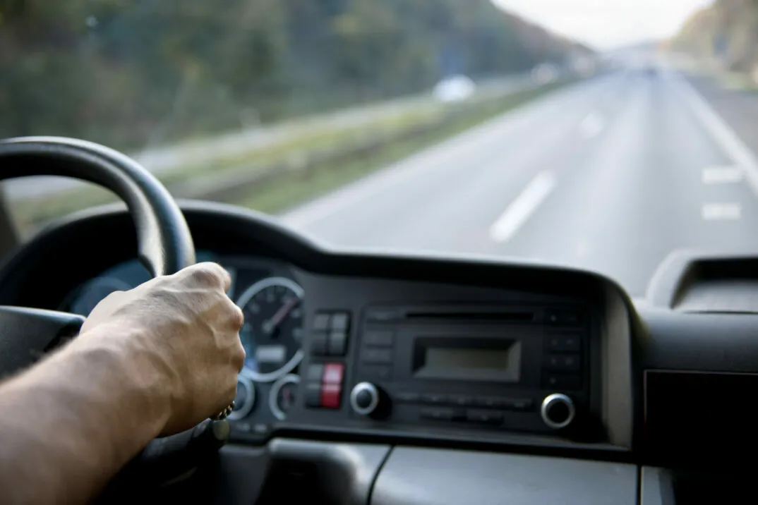 Close up of hand on truck steering wheel