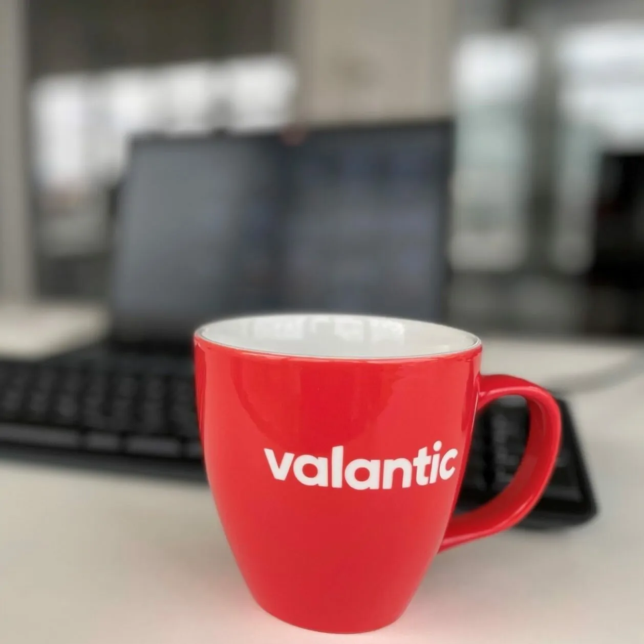 Image of a cup with the valantic logo on it - your partner for digital transformation