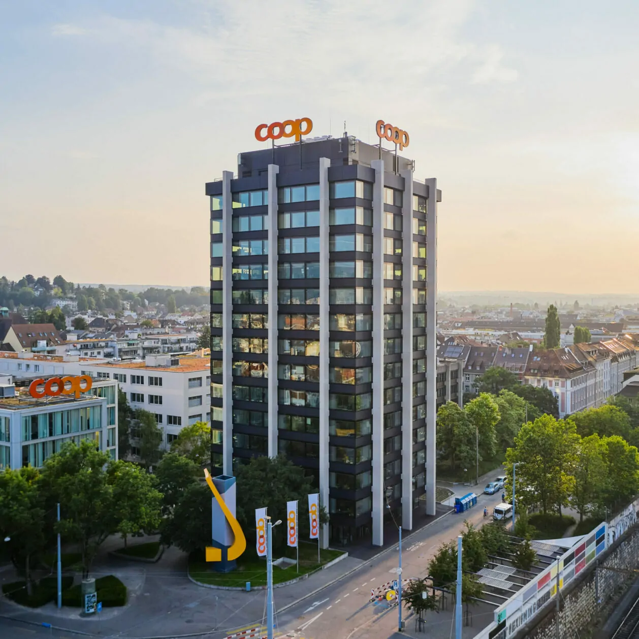 Bild vom Coop Hauptsitz mit Sonne im Hintergrund, SAP Commerce