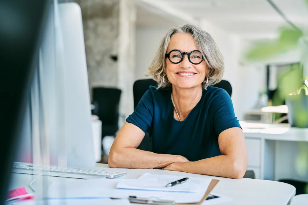 Image of smiling woman at desk