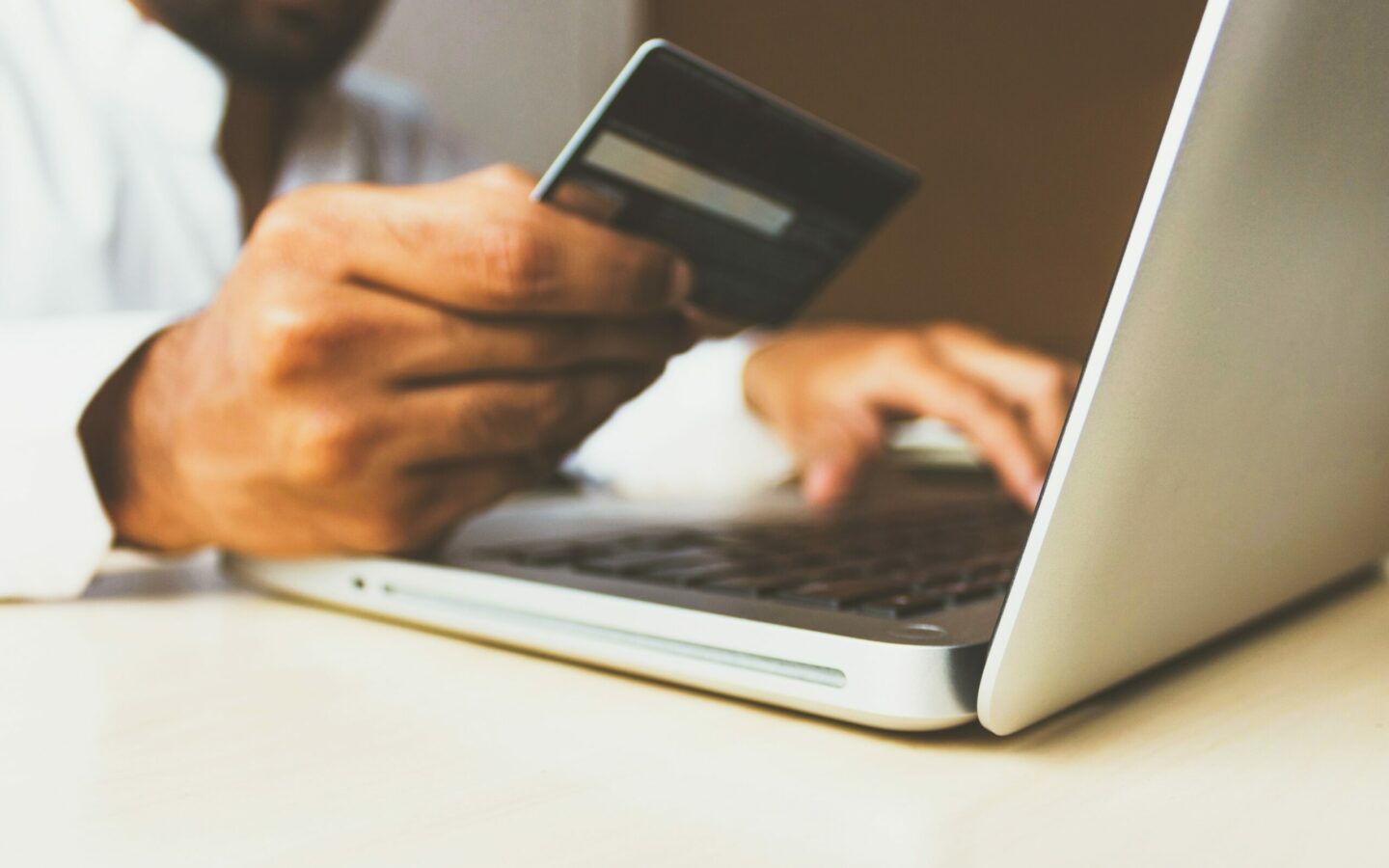 Picture of a man paying online with credit card.