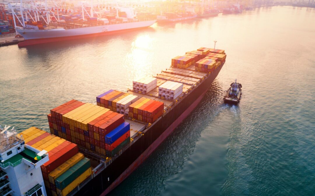 Image of a container ship entering an industrial port; valantic Smart Industries & Industrie 4.0