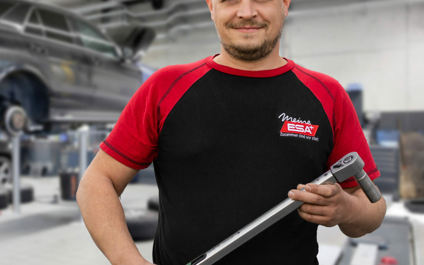 Photo of an ESA employee holding a tool in his hands.