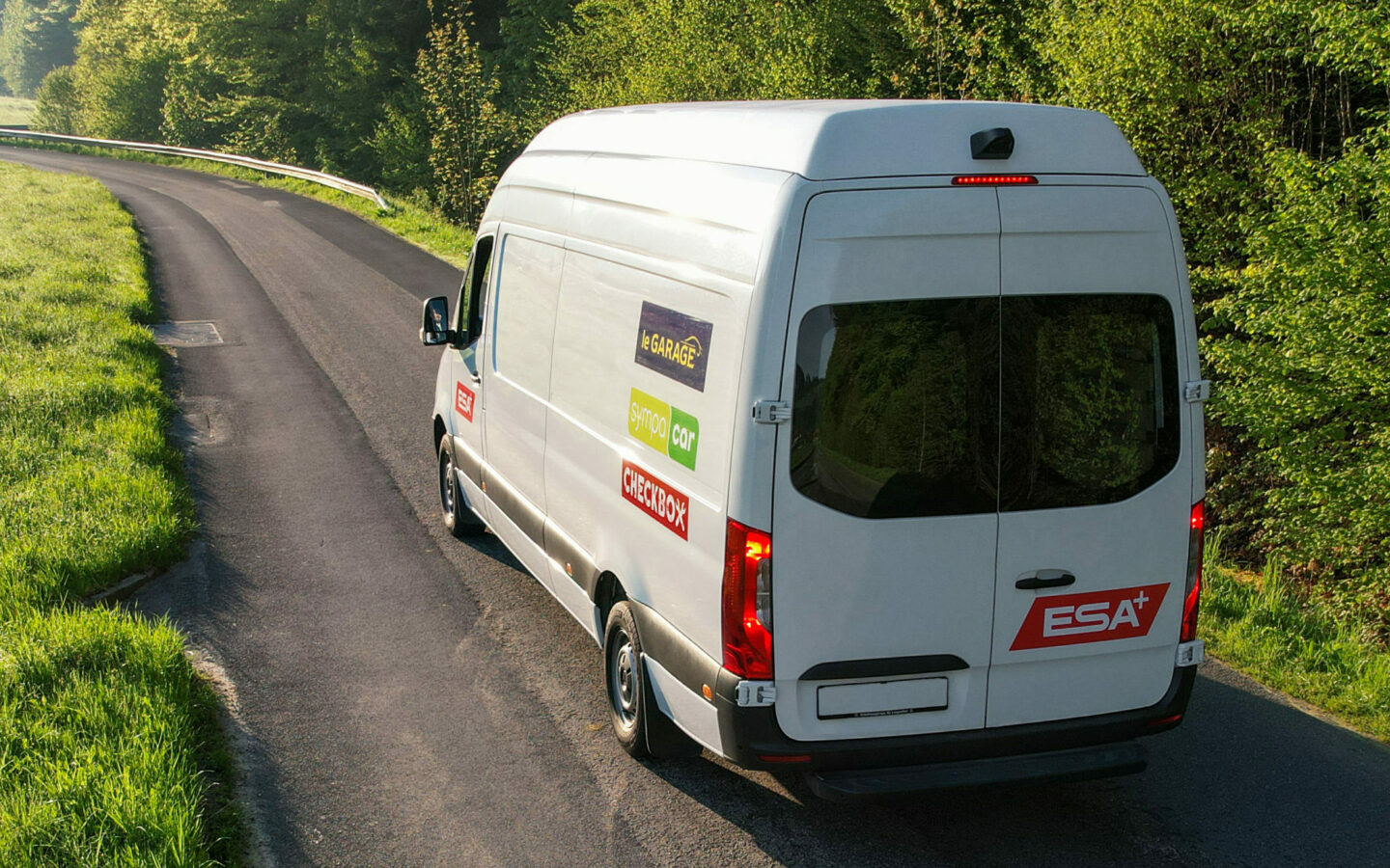 Photo of an ESA transporter driving down a country road.