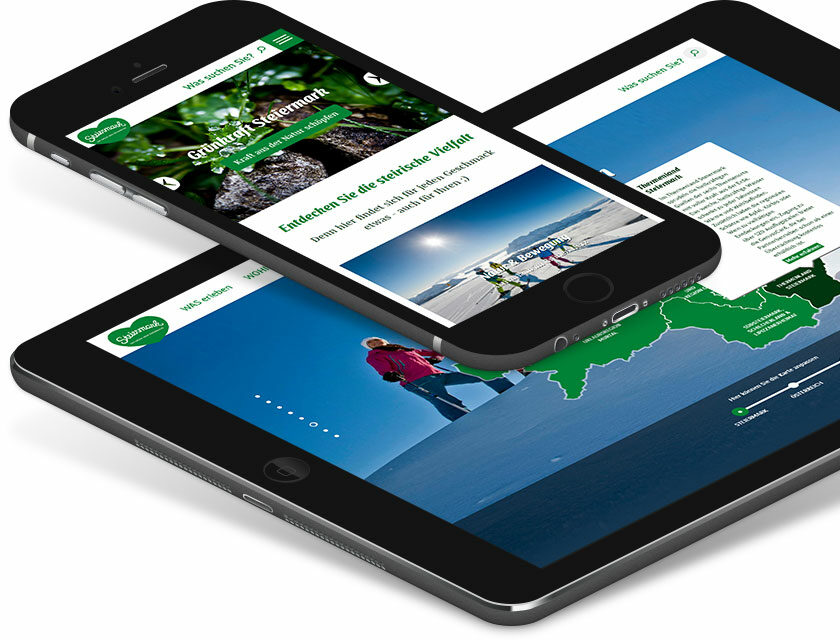 Bild von einem Smartphone und einem Tablet, die Details der Steiermark-Website zeigen.