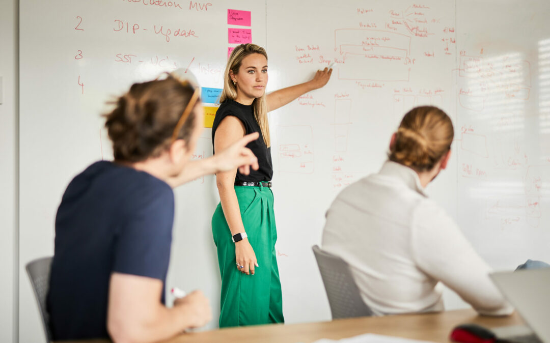 A woman in a meeting, listening attentively.