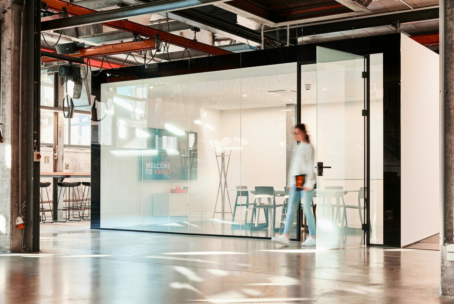 A young woman shows a presentation deck to her colleague.