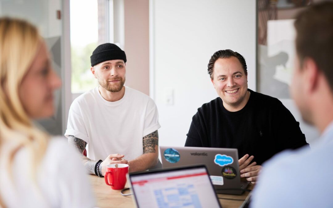 Two teams consisting of four people discuss their strategy.