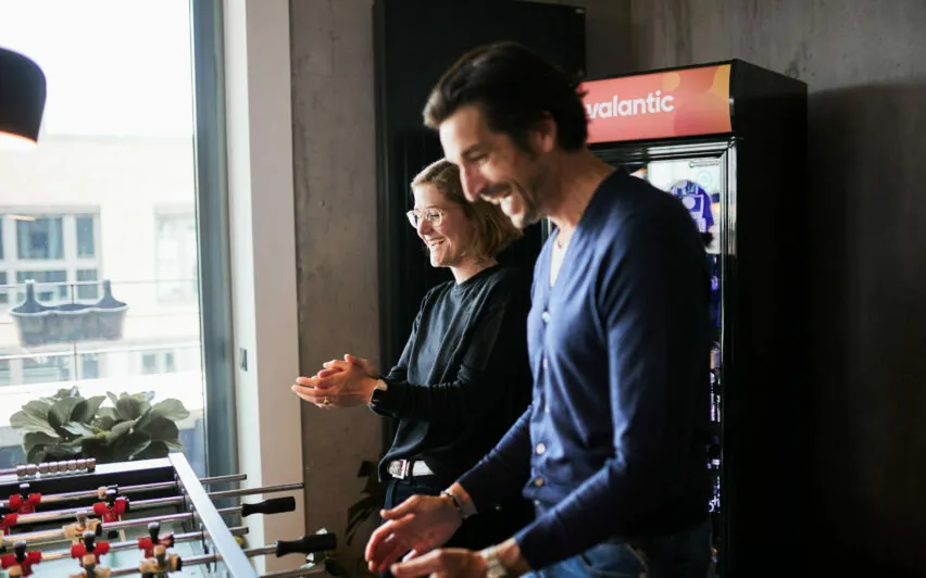 A woman and a man winning at foosball.