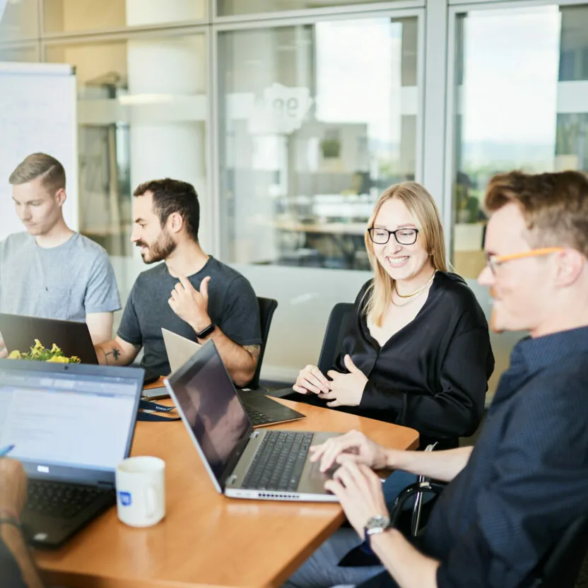 Photo of four people during a business meeting.