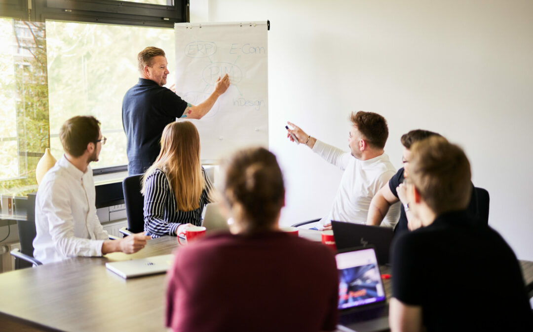 Photo of a group of team members working on a strategy together.