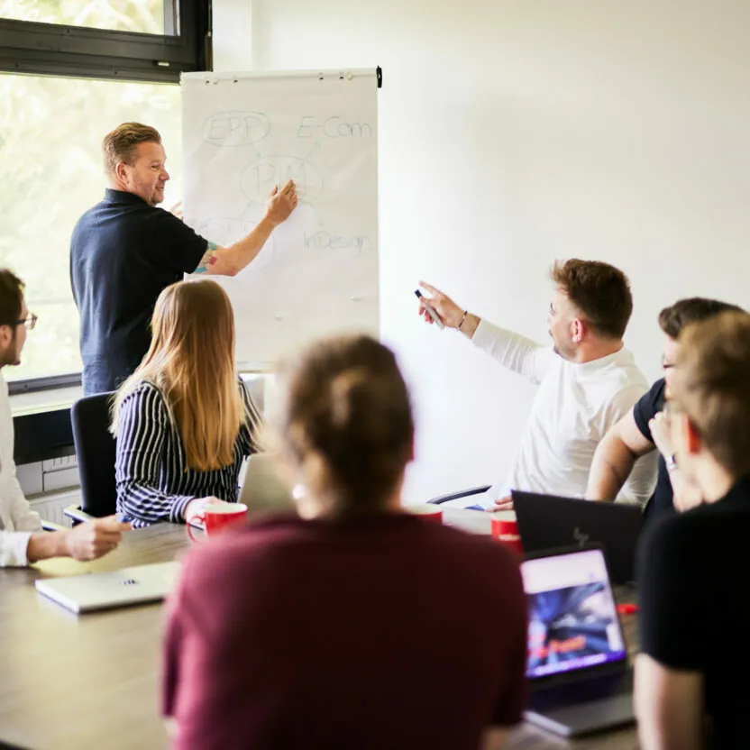 Photo of a group of team members working on a strategy together.