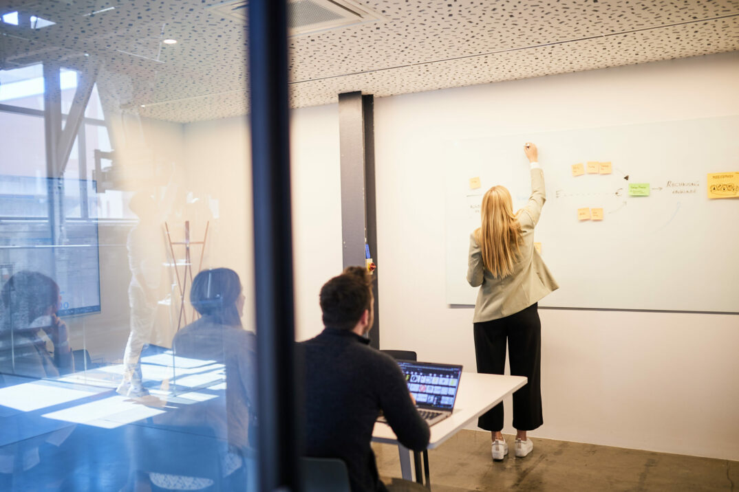 Photo of a group of colleagues sitting in a meeting room.