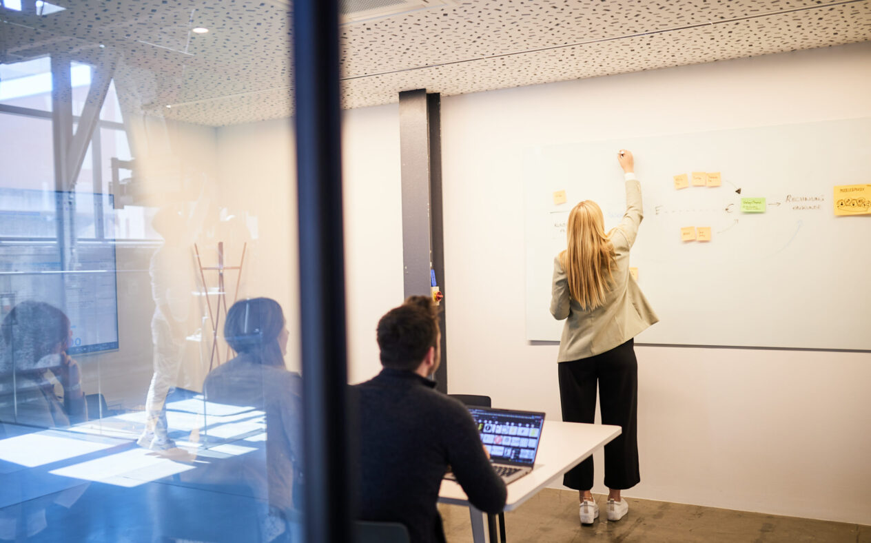 Photo of a group of colleagues sitting in a meeting room.
