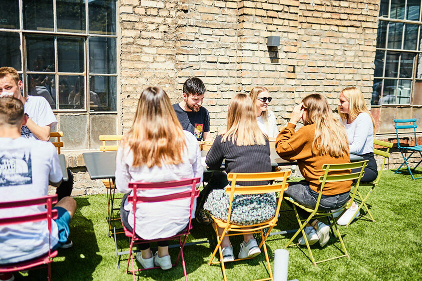 Photo of colleagues having lunch together outdoors.