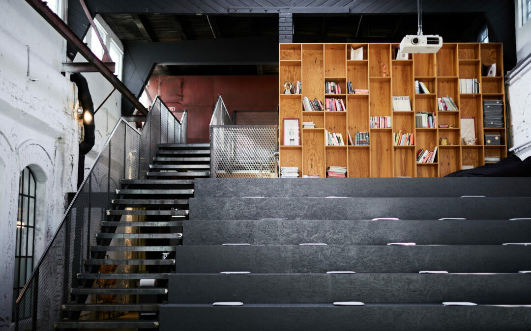 Photo of an office library with dark seating steps.