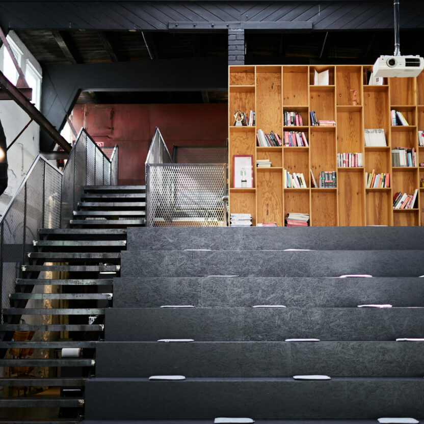 Photo of an office library with dark seating steps.