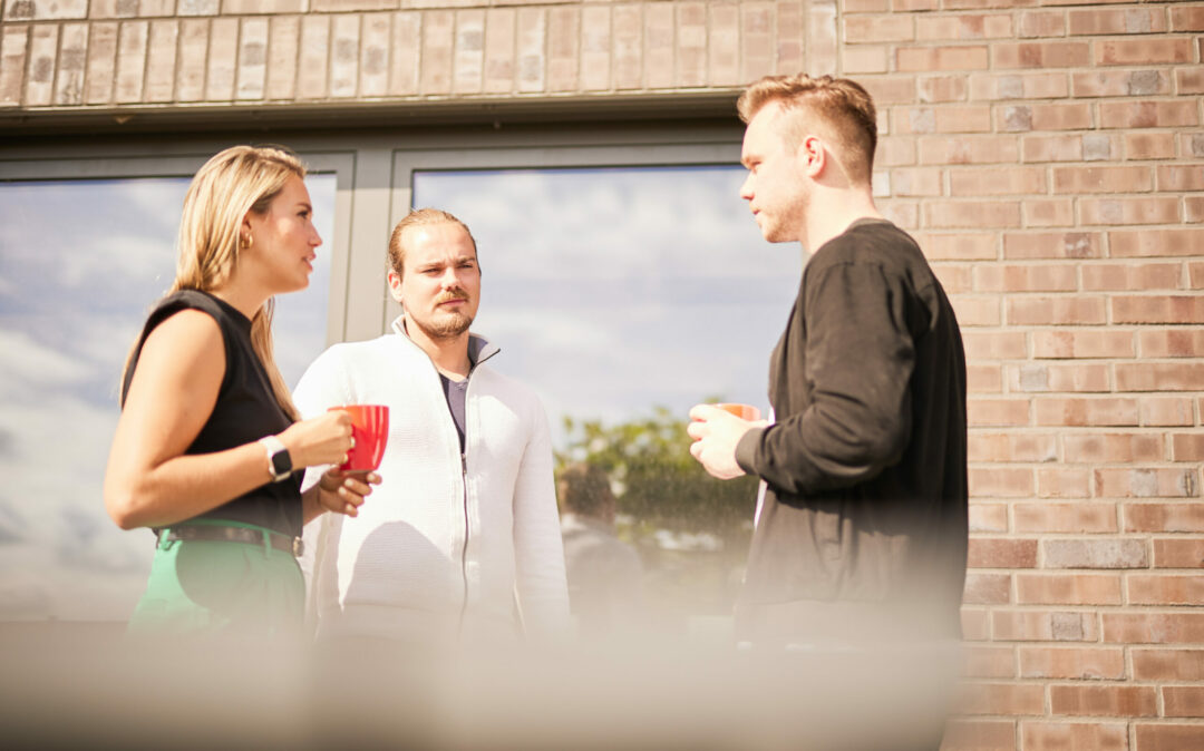 Three valantic CX colleagues taking a break on the terrace.