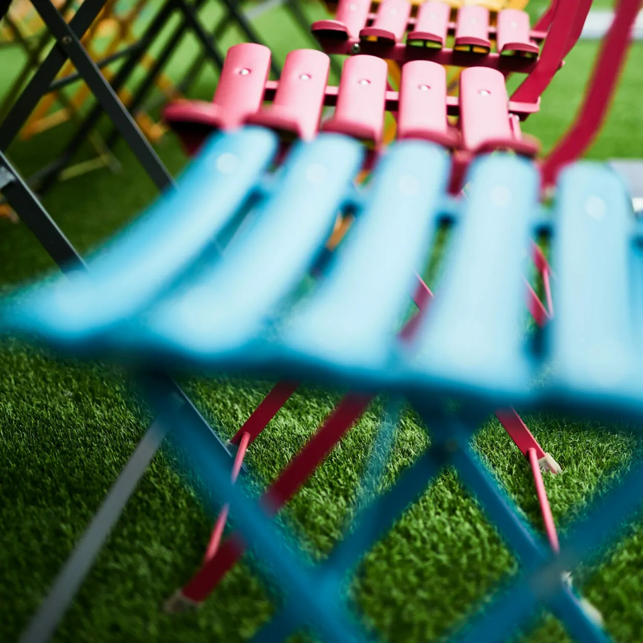 Close up of colorful patio chairs.