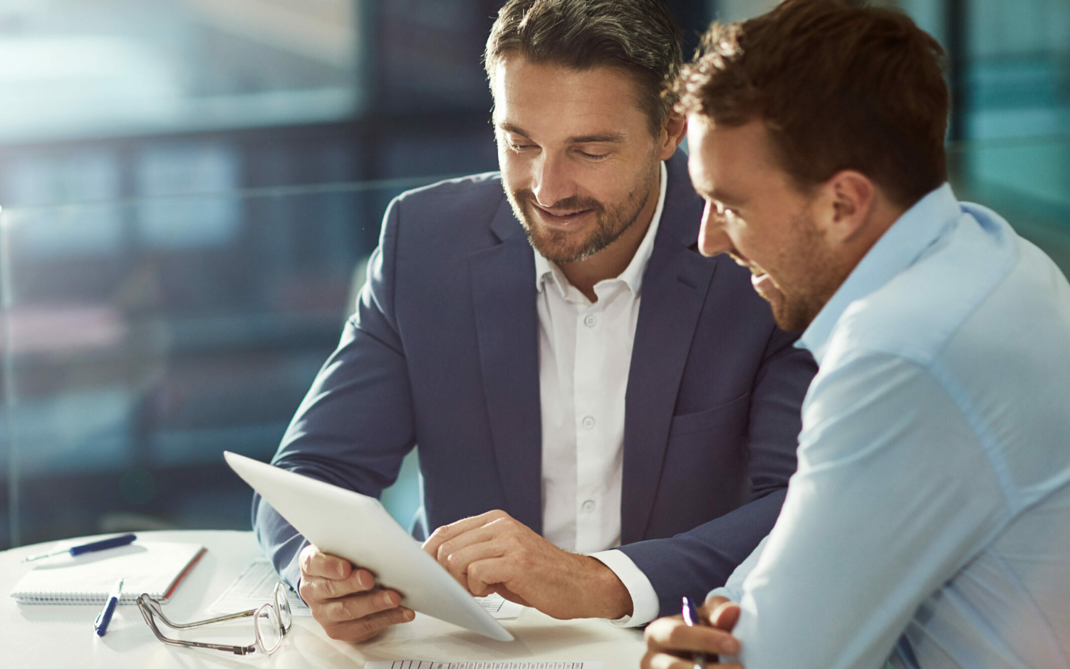 business men looking at tablet