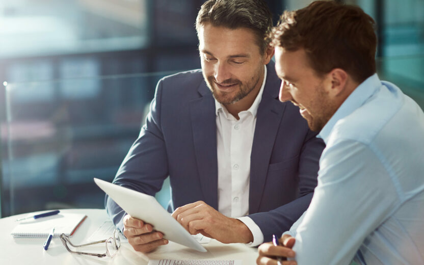 business men looking at tablet